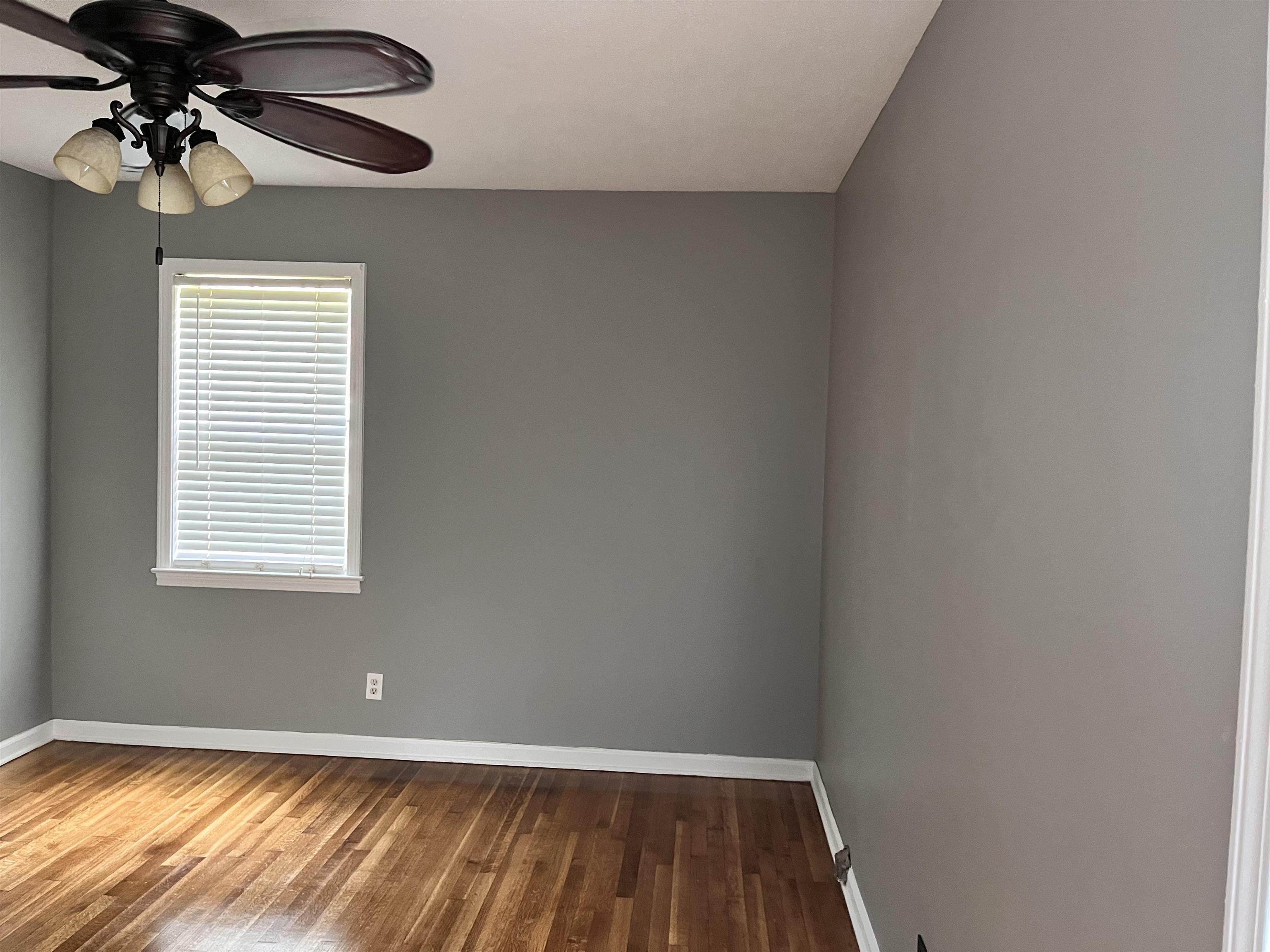 4282 Millbranch Road Memphis, TN 38116 - Photo 16 of 28 Empty room featuring wood finished floors and ceiling fan