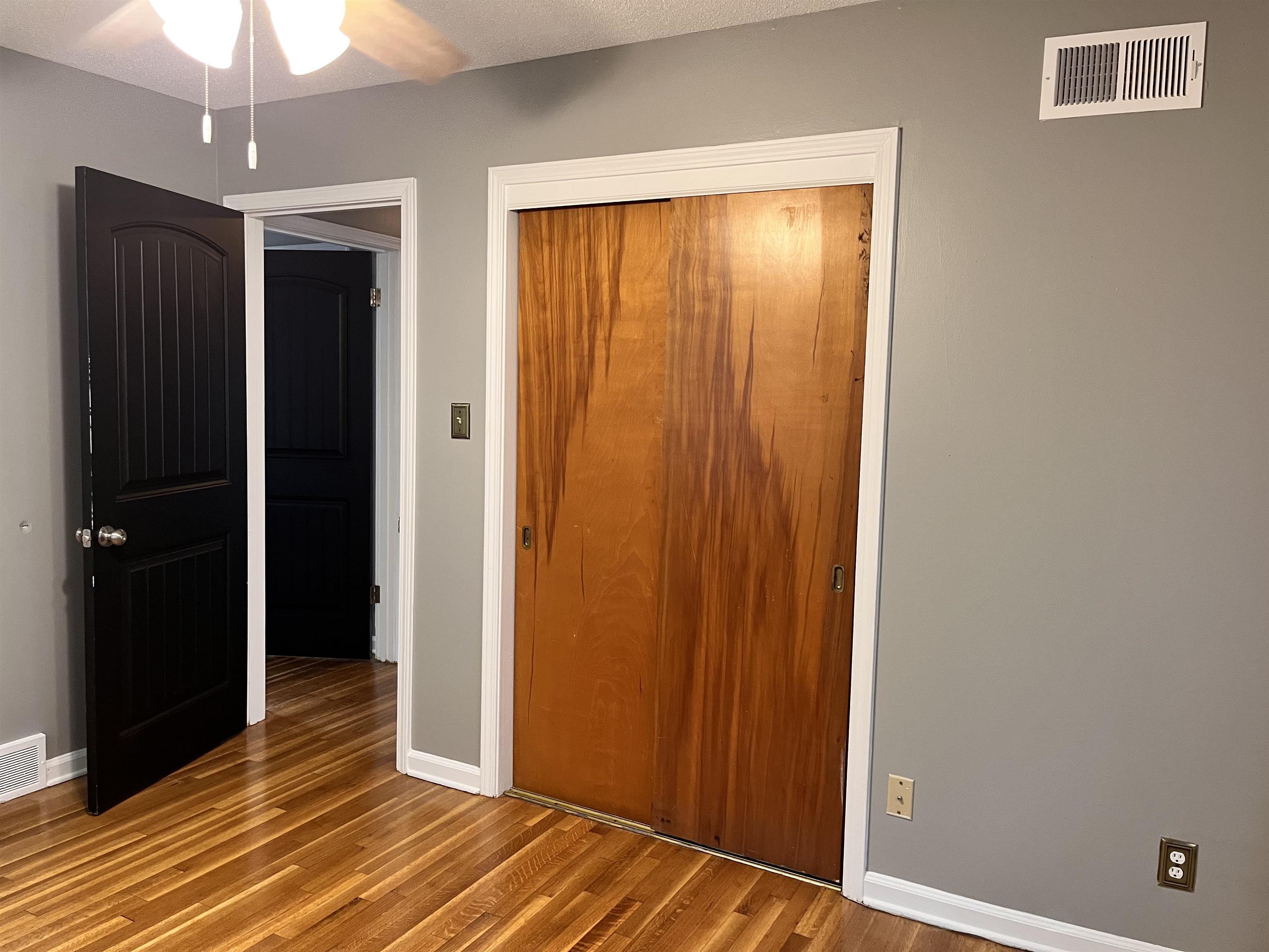 4282 Millbranch Road Memphis, TN 38116 - Photo 18 of 28 Unfurnished bedroom featuring wood finished floors and a closet
