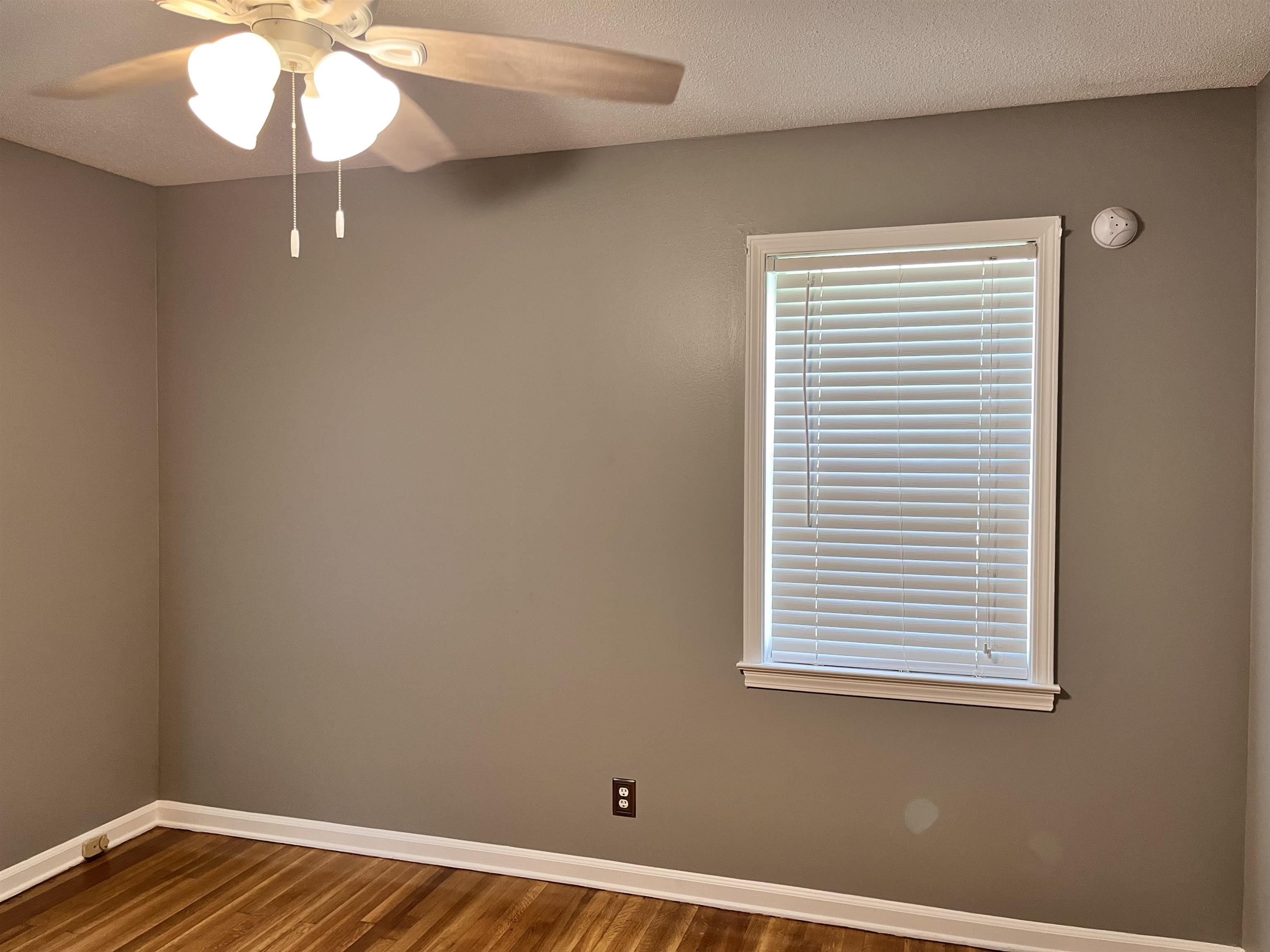 4282 Millbranch Road Memphis, TN 38116 - Photo 19 of 28 Empty room featuring dark wood-style flooring and ceiling fan