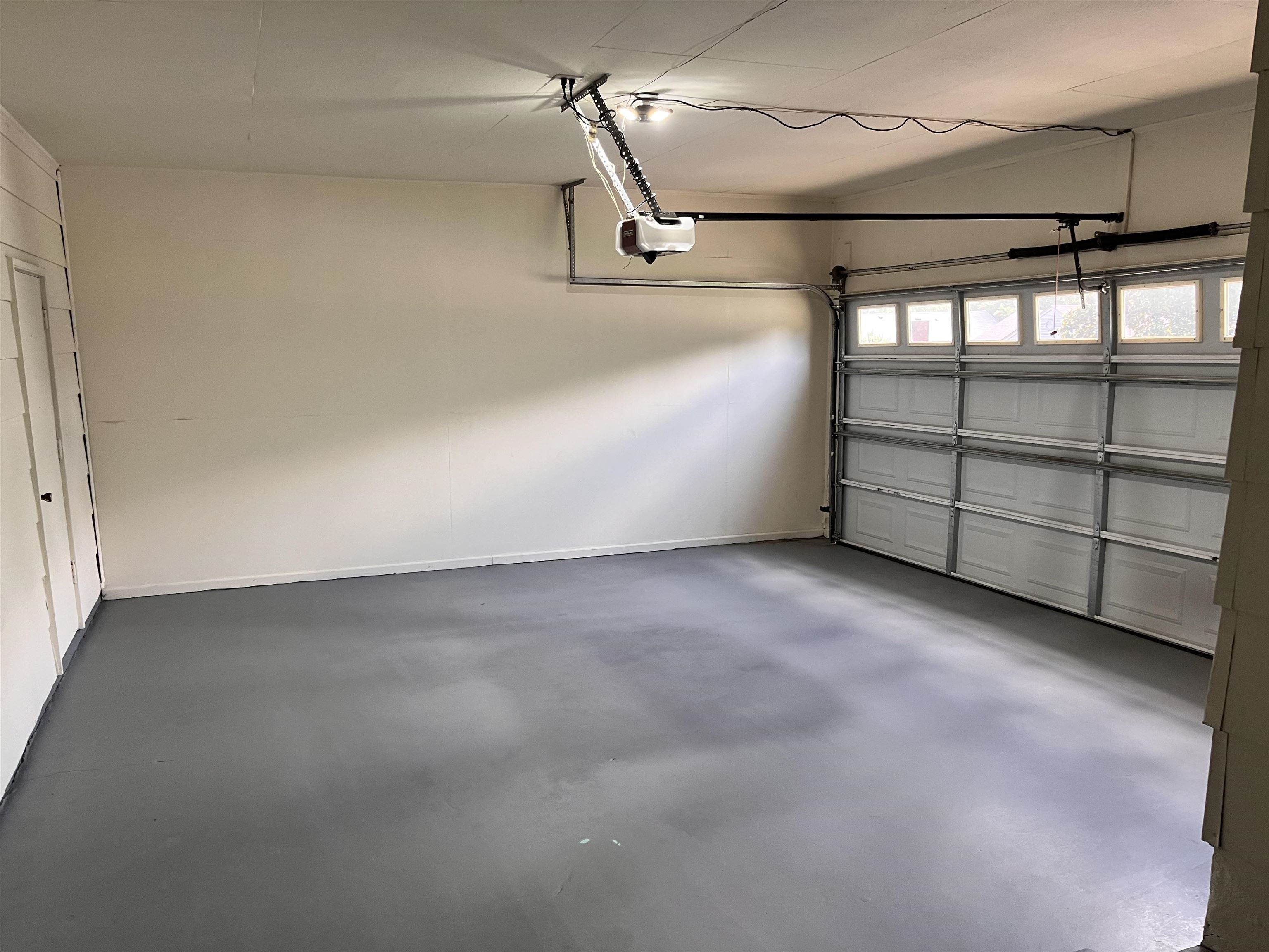 4282 Millbranch Road Memphis, TN 38116 - Photo 21 of 28 Garage with a garage door opener and baseboards