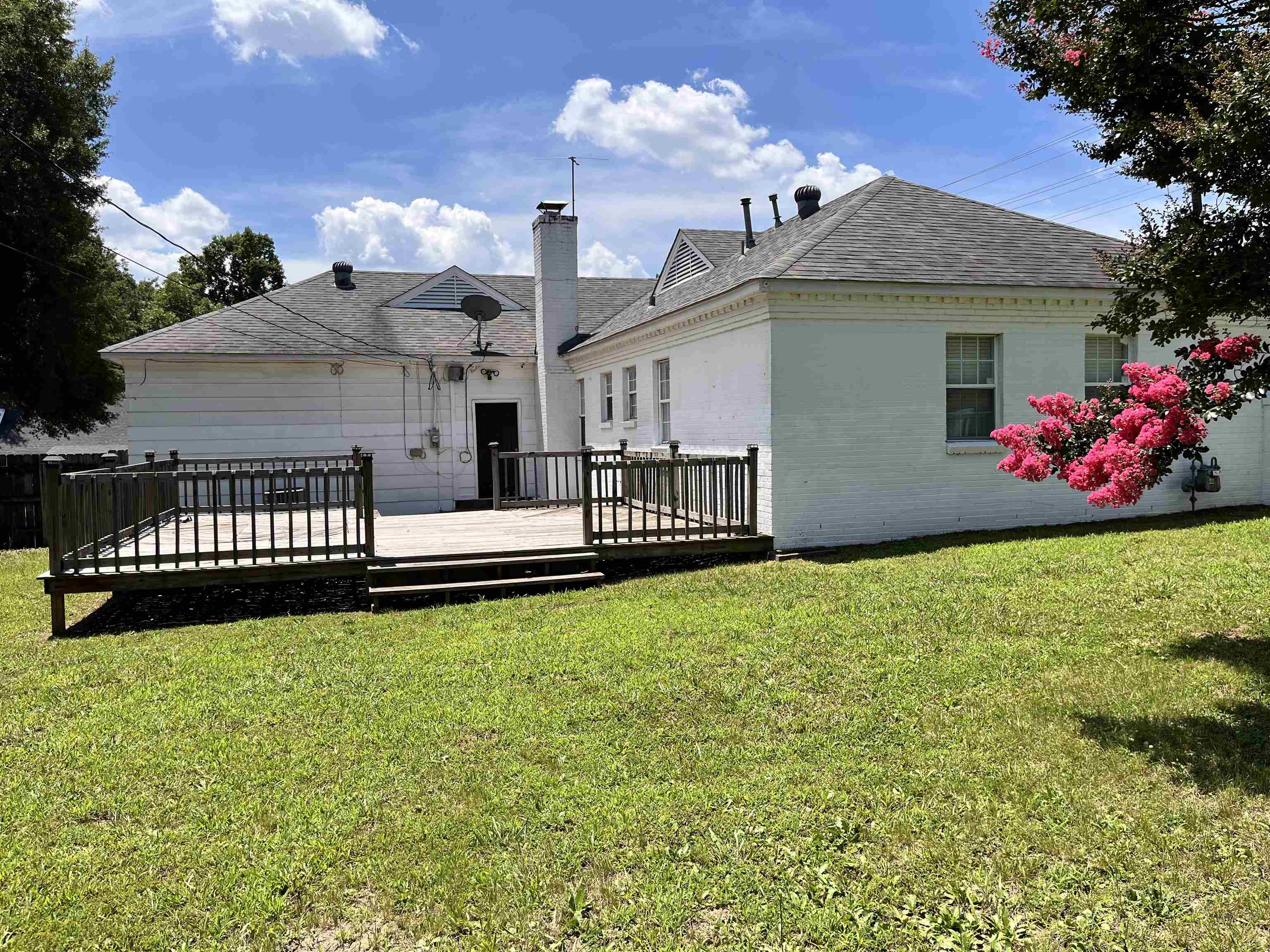 4282 Millbranch Road Memphis, TN 38116 - Photo 25 of 28 Back of house with a wooden deck, a yard, a chimney, and roof with shingles