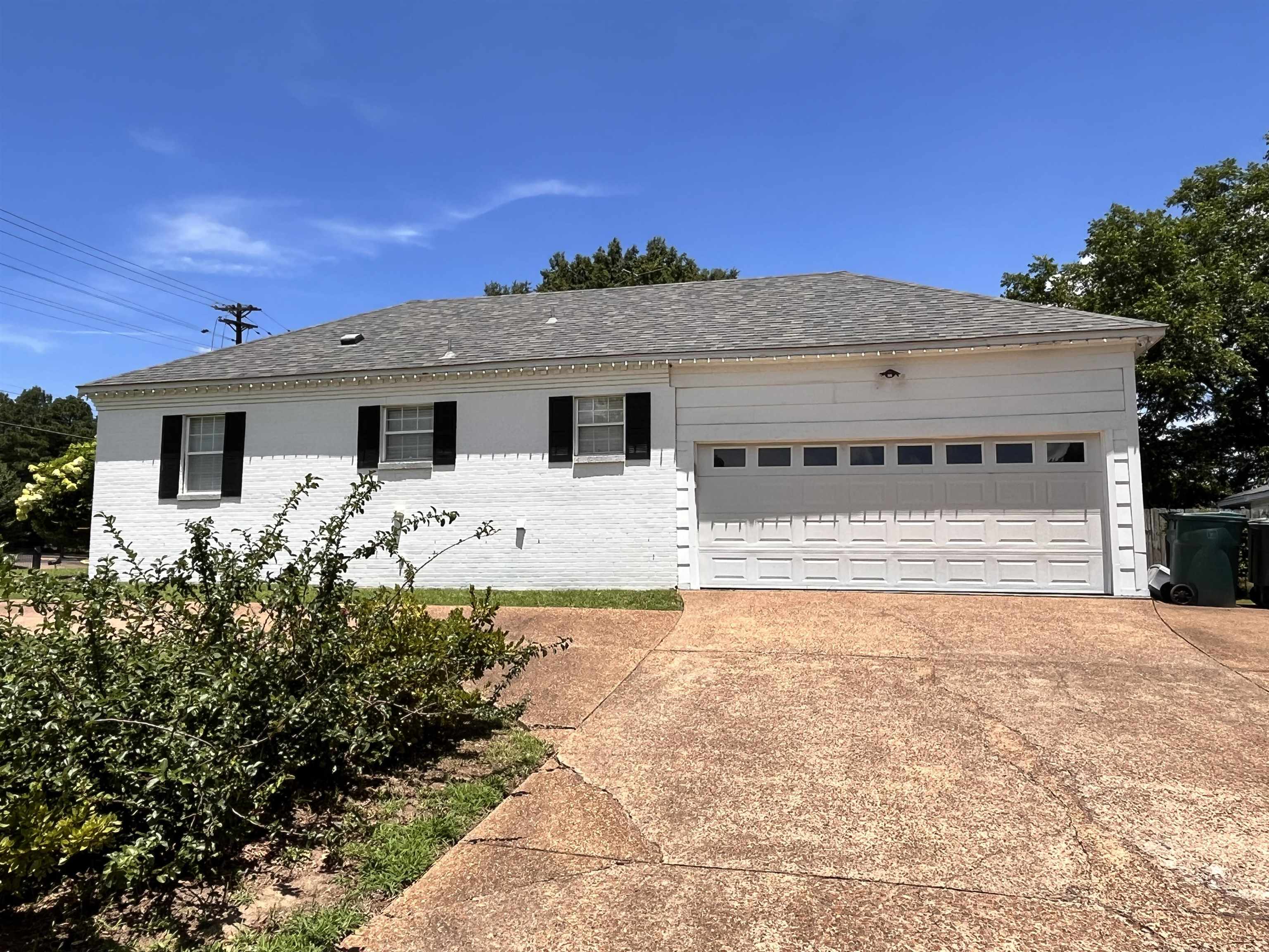 4282 Millbranch Road Memphis, TN 38116 - Photo 28 of 28 Ranch-style house with concrete driveway, a garage, brick siding, and roof with shingles