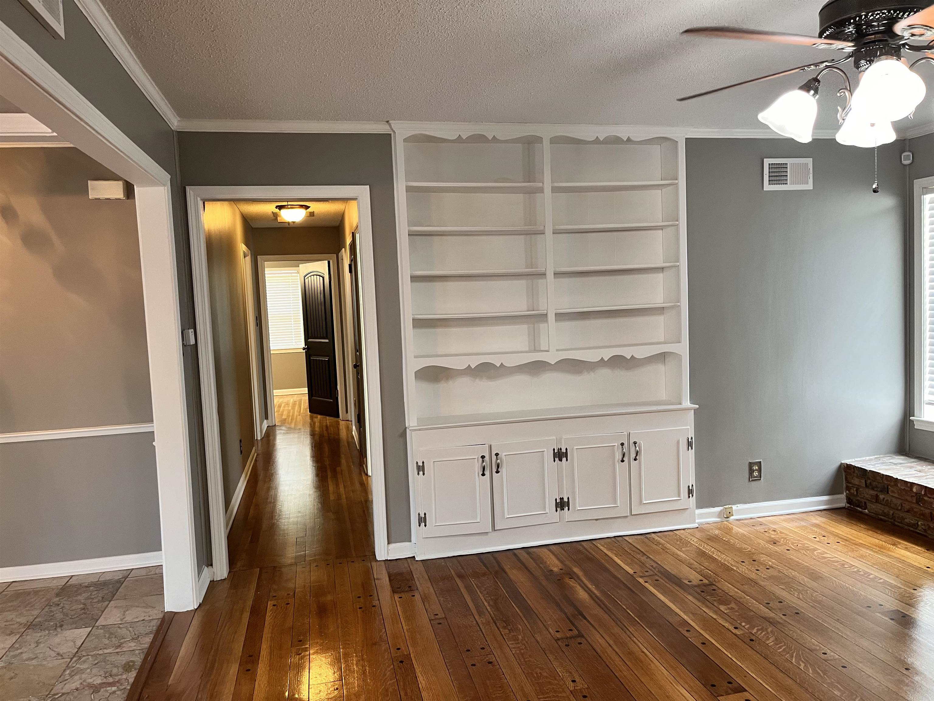 4282 Millbranch Road Memphis, TN 38116 - Photo 6 of 28 Interior space with ceiling fan, a textured ceiling, dark wood finished floors, and ornamental molding