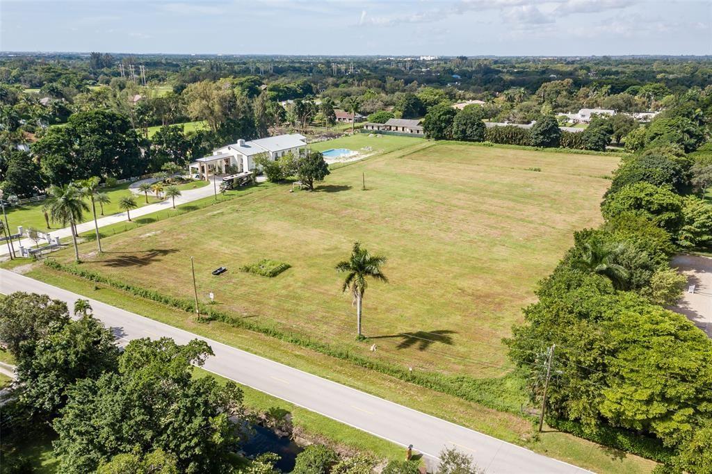 6301 Appaloosa Trail Southwest Ranches, FL 33330 - Photo 7 of 10 a view of a swimming pool with a lawn chairs