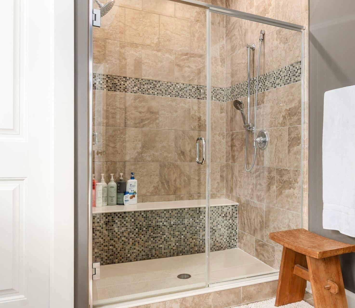 1002 Rambling Brook Way Delaware, OH 43015 - Photo 41 of 104 The Primary Suite features an elegant tray ceiling, wall of windows and attached full bath with double vanity, private water closet, glass shower and dual closets.