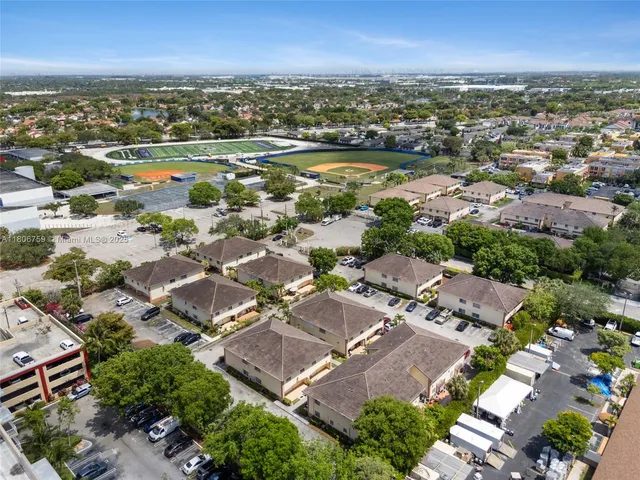 an aerial view of residential houses with outdoor space
