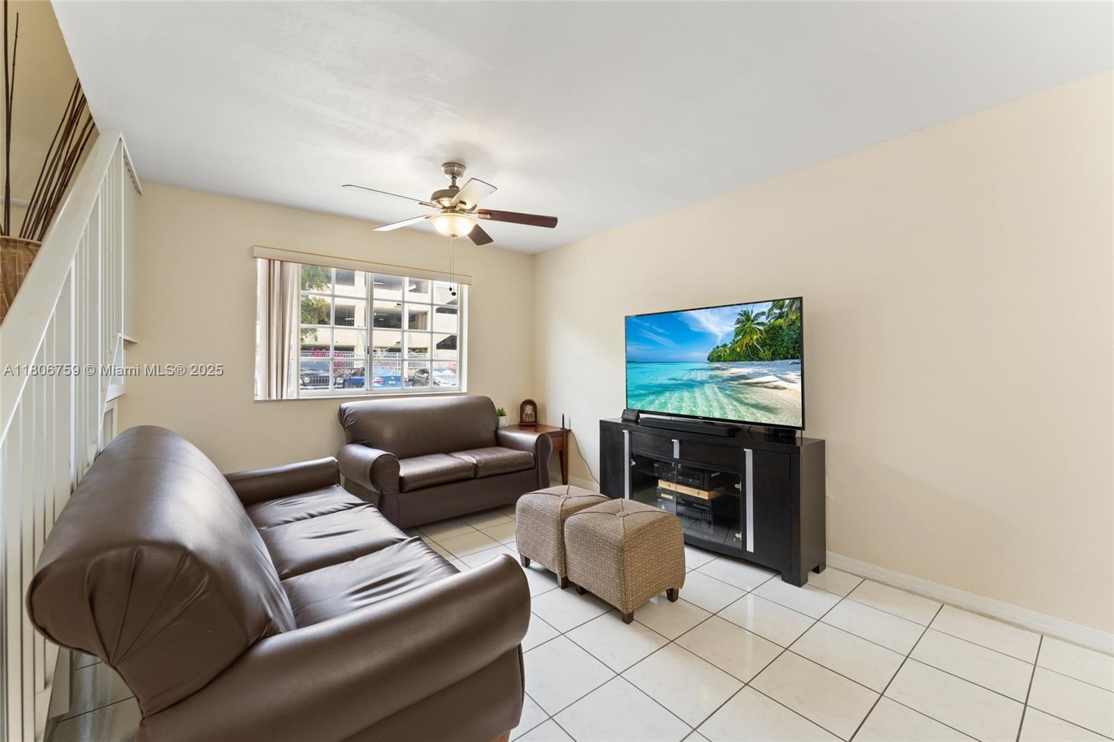 6755 Northwest 182nd Street, Unit 104 Hialeah, FL 33015 - Photo 13 of 33 a living room with furniture and a flat screen tv