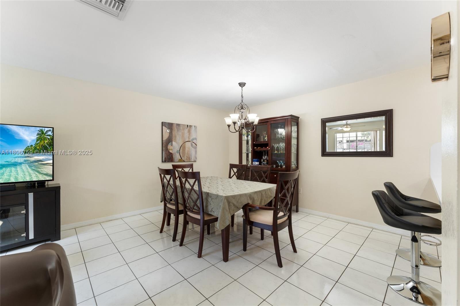 6755 Northwest 182nd Street, Unit 104 Hialeah, FL 33015 - Photo 14 of 33 a view of a dining room with furniture