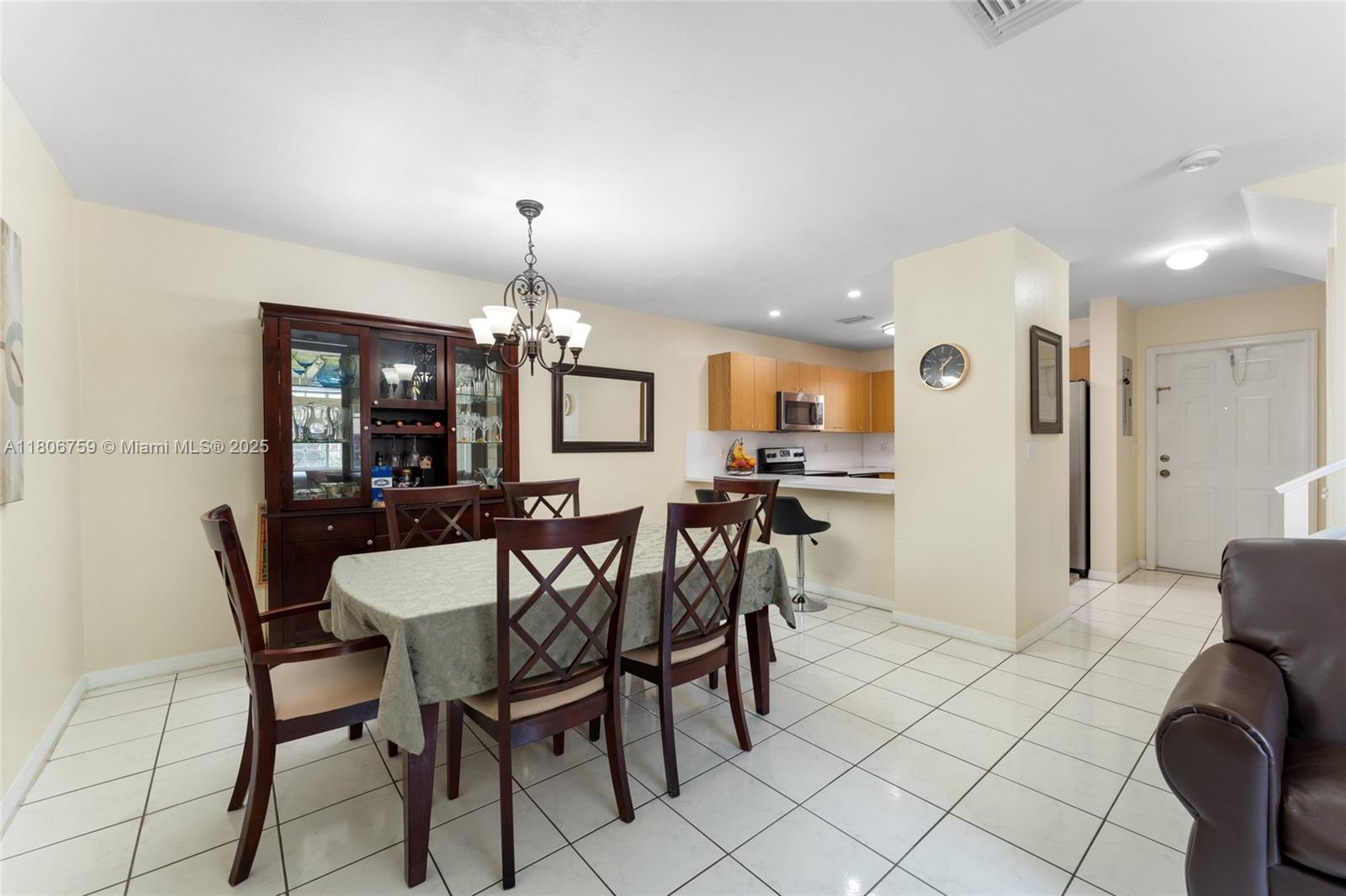 6755 Northwest 182nd Street, Unit 104 Hialeah, FL 33015 - Photo 15 of 33 a view of a dining room with furniture