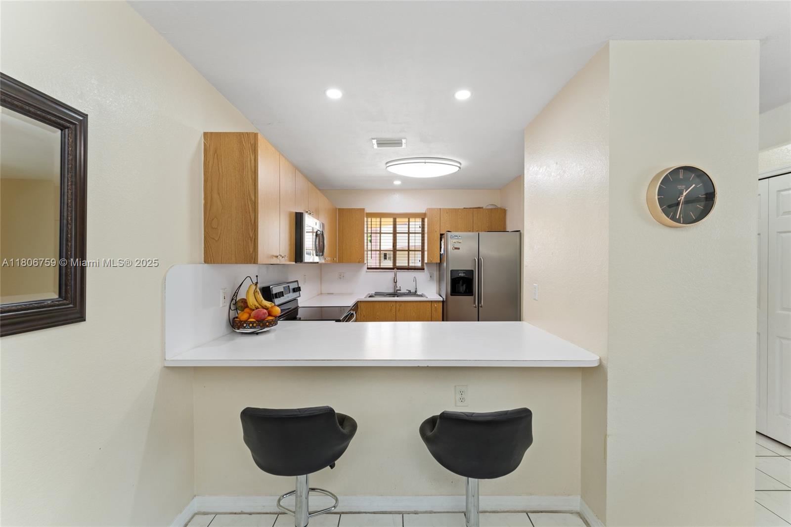 6755 Northwest 182nd Street, Unit 104 Hialeah, FL 33015 - Photo 20 of 33 a view of kitchen island a sink and wooden floor