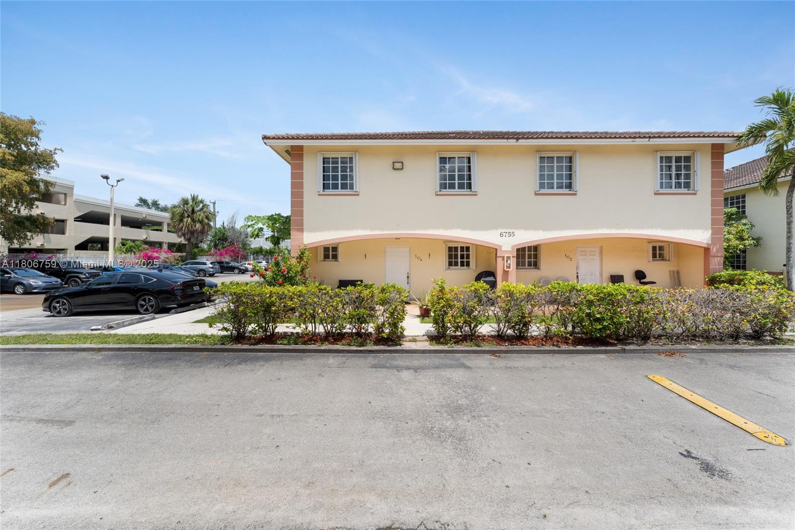 6755 Northwest 182nd Street, Unit 104 Hialeah, FL 33015 - Photo 2 of 33 front view of a house with a yard