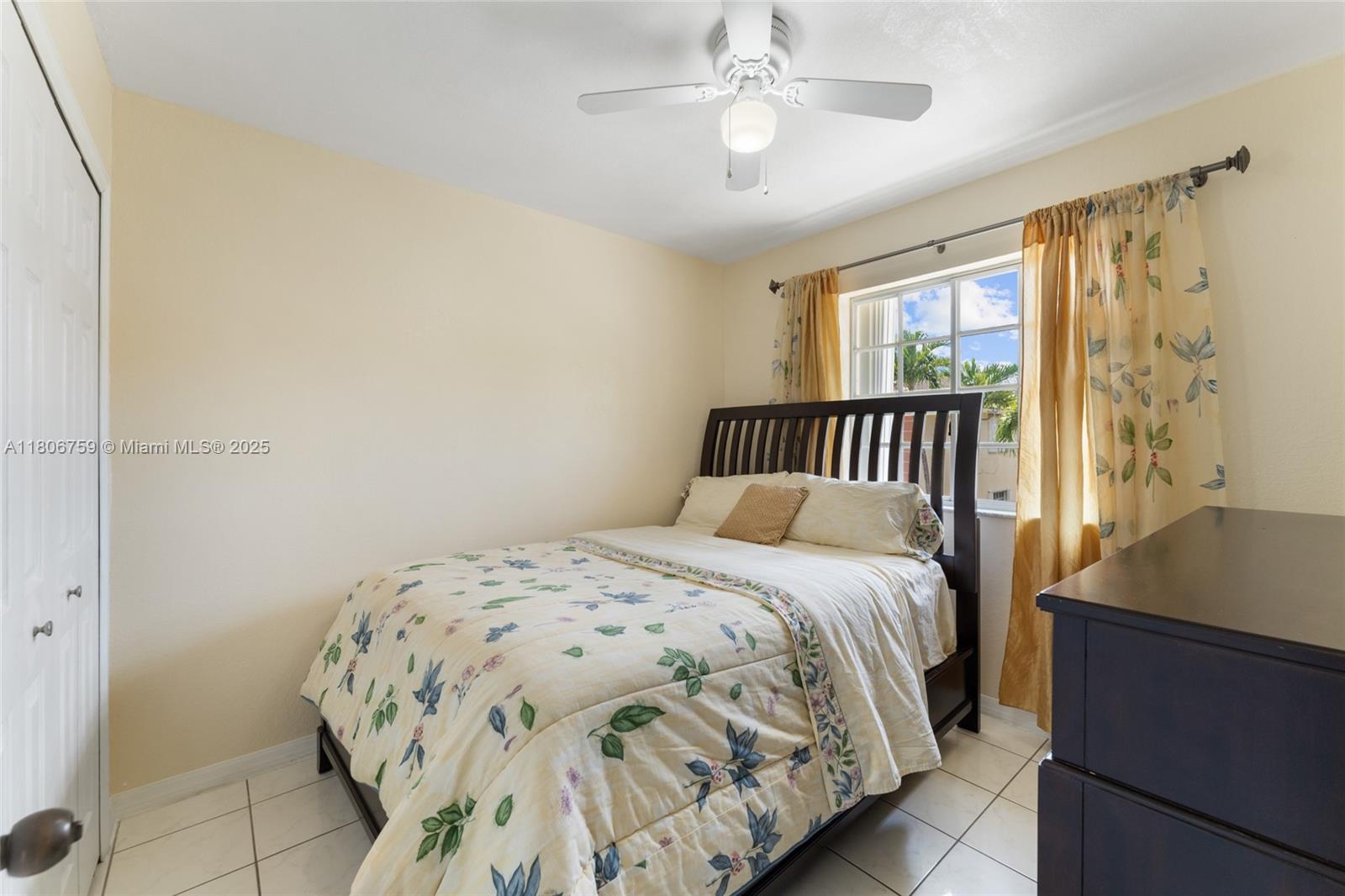 6755 Northwest 182nd Street, Unit 104 Hialeah, FL 33015 - Photo 23 of 33 a bedroom with a bed and a window