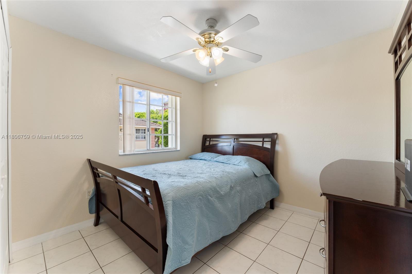 6755 Northwest 182nd Street, Unit 104 Hialeah, FL 33015 - Photo 25 of 33 a bedroom with a bed and a chair