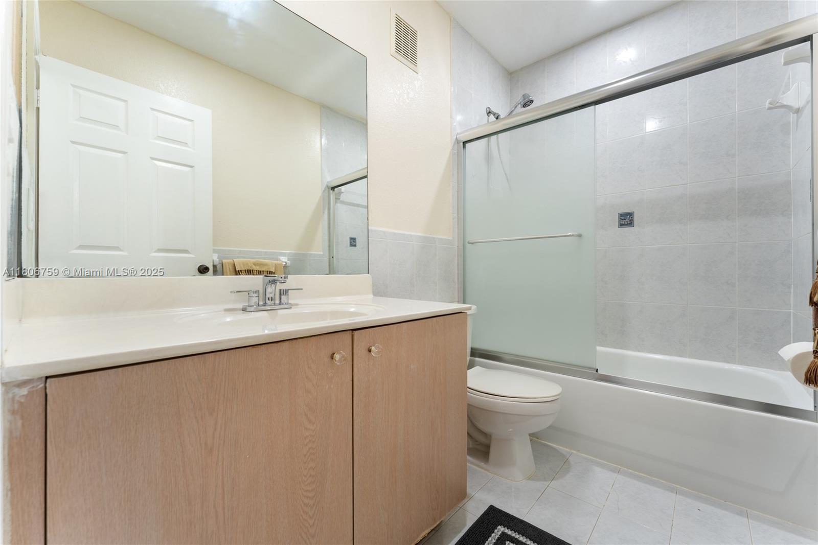 6755 Northwest 182nd Street, Unit 104 Hialeah, FL 33015 - Photo 28 of 33 a bathroom with a sink a toilet and shower