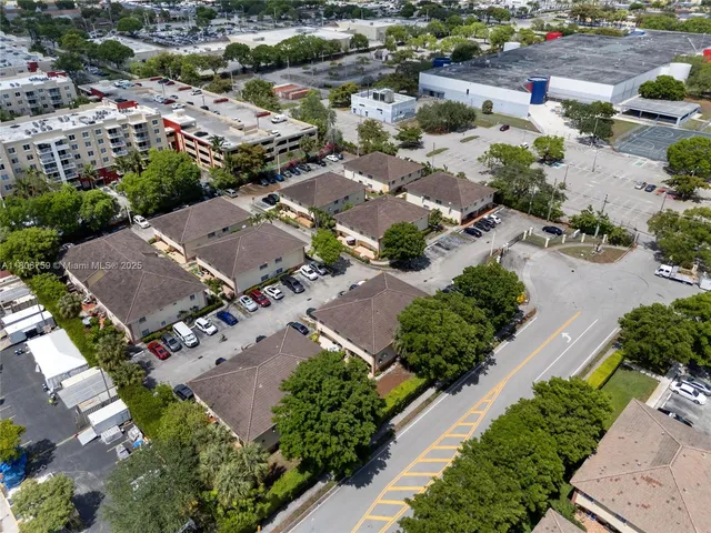 an aerial view of residential houses with outdoor space
