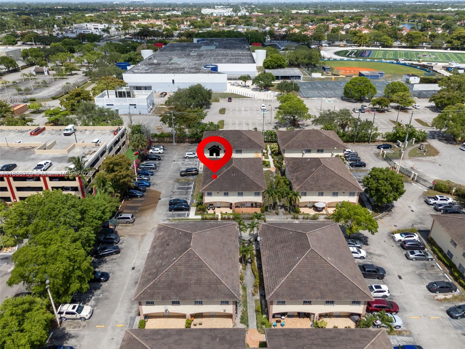 6755 Northwest 182nd Street, Unit 104 Hialeah, FL 33015 - Photo 7 of 33 an aerial view of residential houses with outdoor space and parking