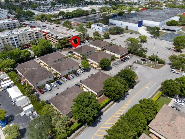 an aerial view of a houses with greenery