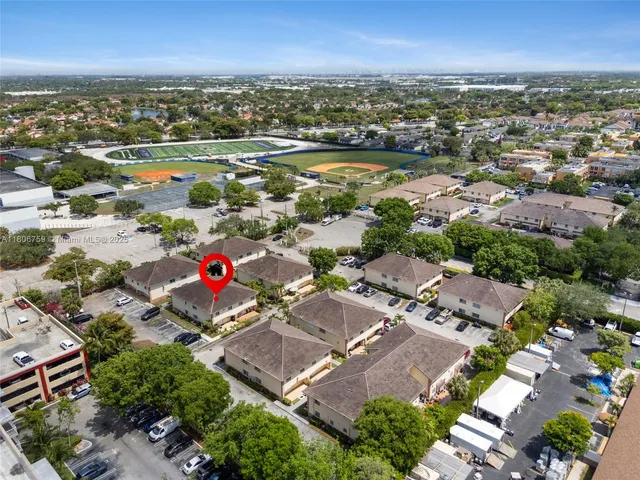 an aerial view of residential houses with outdoor space