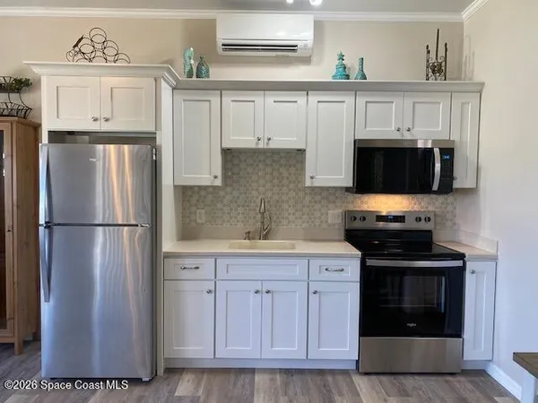 a kitchen with a refrigerator and a stove