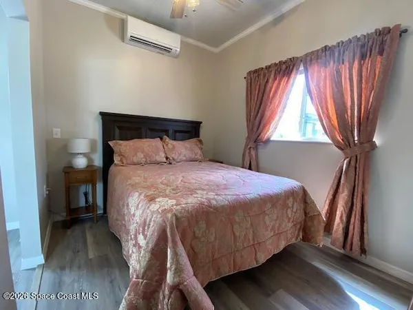 a bed sitting in a bedroom next to a window