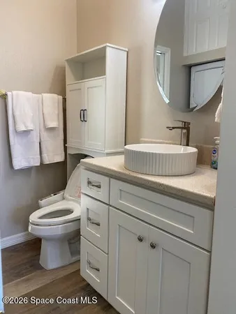 a bathroom with a sink toilet and mirror