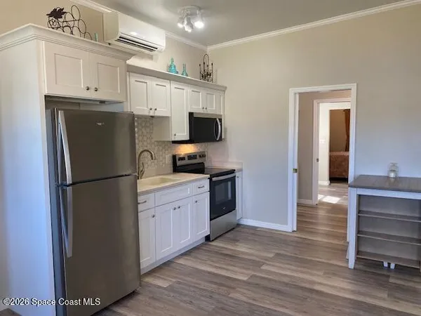a kitchen with stainless steel appliances a refrigerator stove and sink