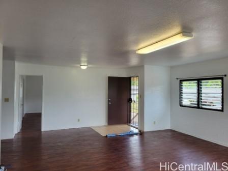 1880 Laniloa Place, Unit B Wahiawa, HI 96786 - Photo 1 of 1 an empty room with wooden floor and windows