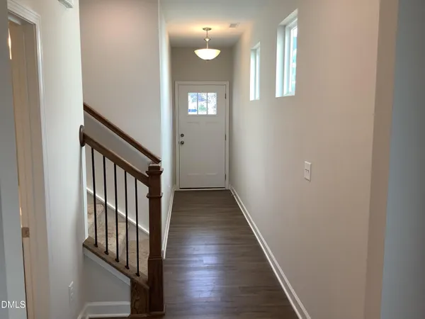 a view of a hallway with wooden floor