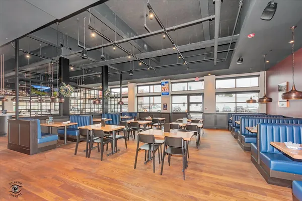 a view of a dining hall with lots of furniture and wooden floor