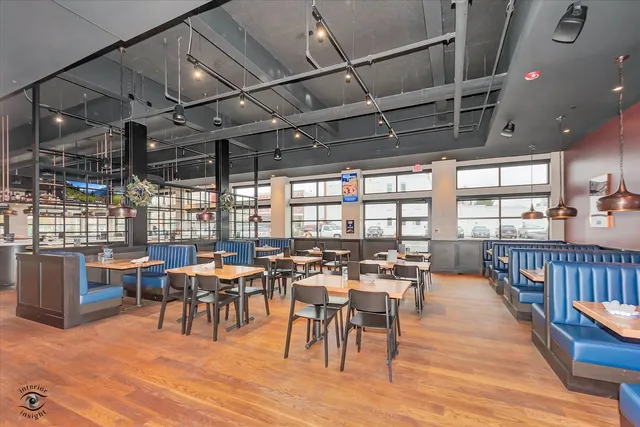 a view of a dining hall with lots of furniture and wooden floor