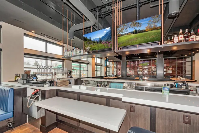 a kitchen with a sink a counter top space appliances and cabinets