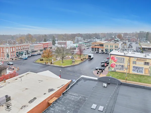 an aerial view of a swimming pool and lounge chairs