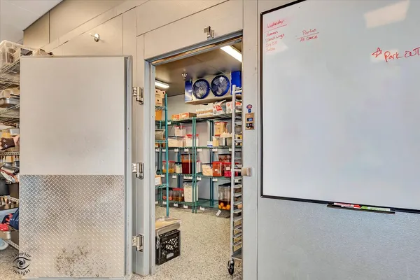 a utility room with lots of appliances and cabinets