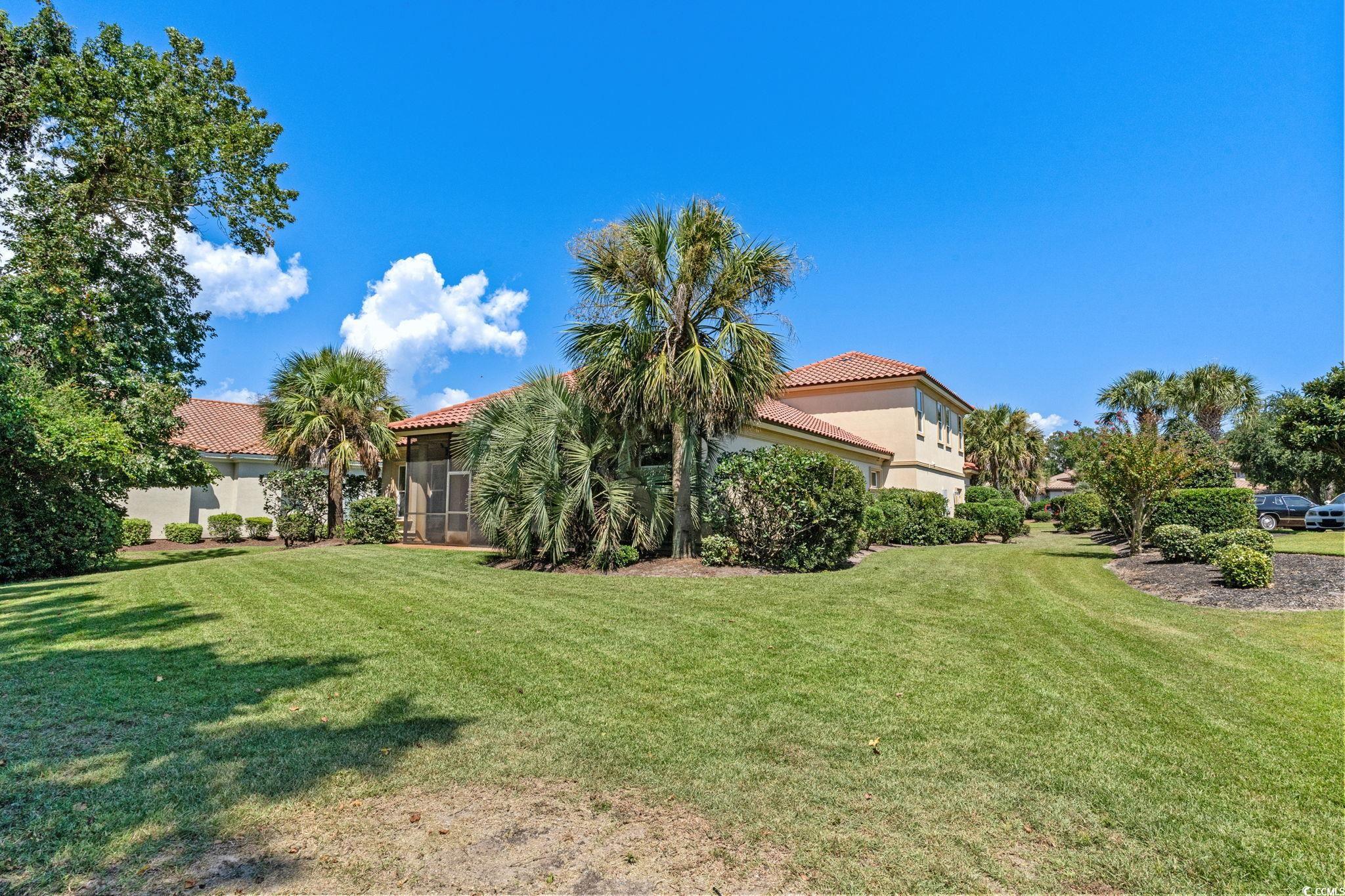 9891 Bellasera Circle Myrtle Beach, SC 29579 - Photo 20 of 40 View of grassy yard featuring a sunroom