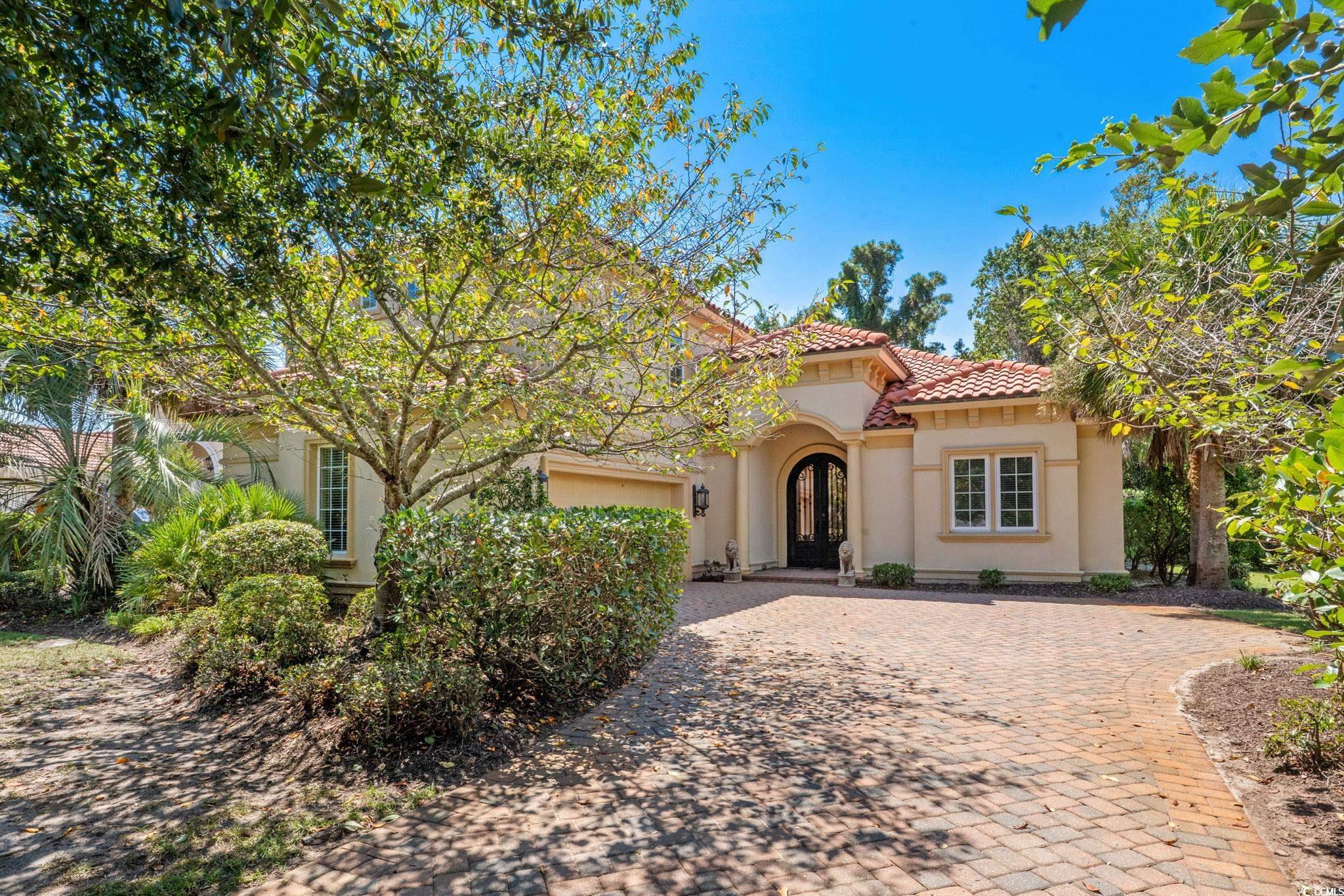 9891 Bellasera Circle Myrtle Beach, SC 29579 - Photo 2 of 40 Mediterranean / spanish-style home featuring decorative driveway, stucco siding, and a tile roof
