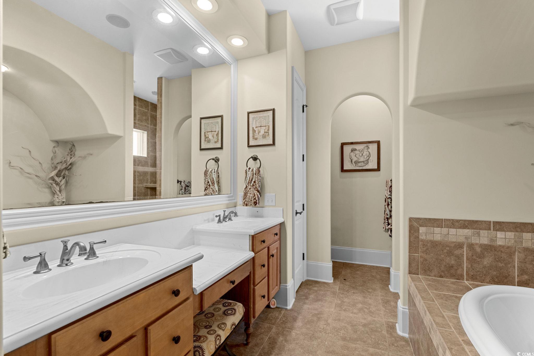 9891 Bellasera Circle Myrtle Beach, SC 29579 - Photo 22 of 40 Full bathroom featuring vanity, a bath, light tile patterned floors, recessed lighting, and tiled shower