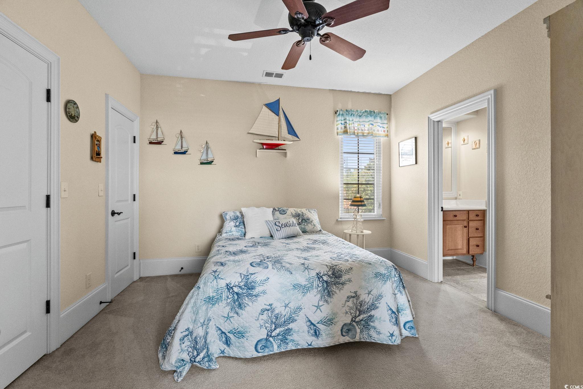 9891 Bellasera Circle Myrtle Beach, SC 29579 - Photo 28 of 40 Bedroom featuring light colored carpet, ensuite bath, and ceiling fan