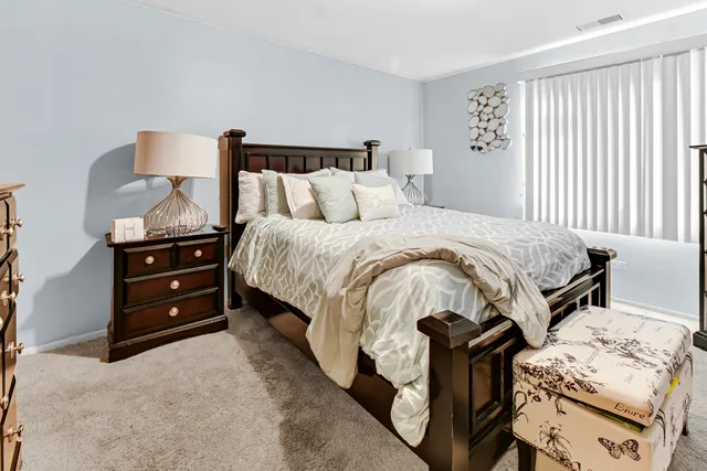 a bathroom with a granite countertop toilet sink and mirror