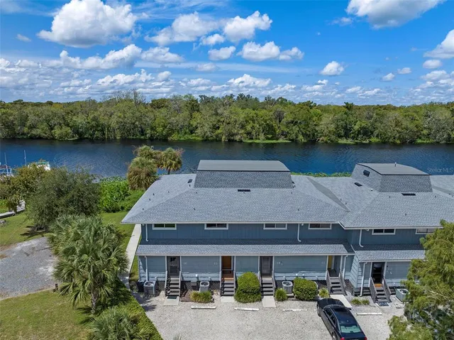 an aerial view of a house with a garden and a yard