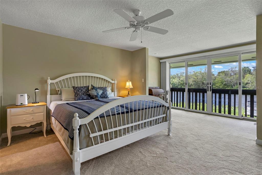 2329 River Ridge Road, Unit 15 DeLand, FL 32720 - Photo 12 of 40 a bedroom with a bed a window and a chandelier