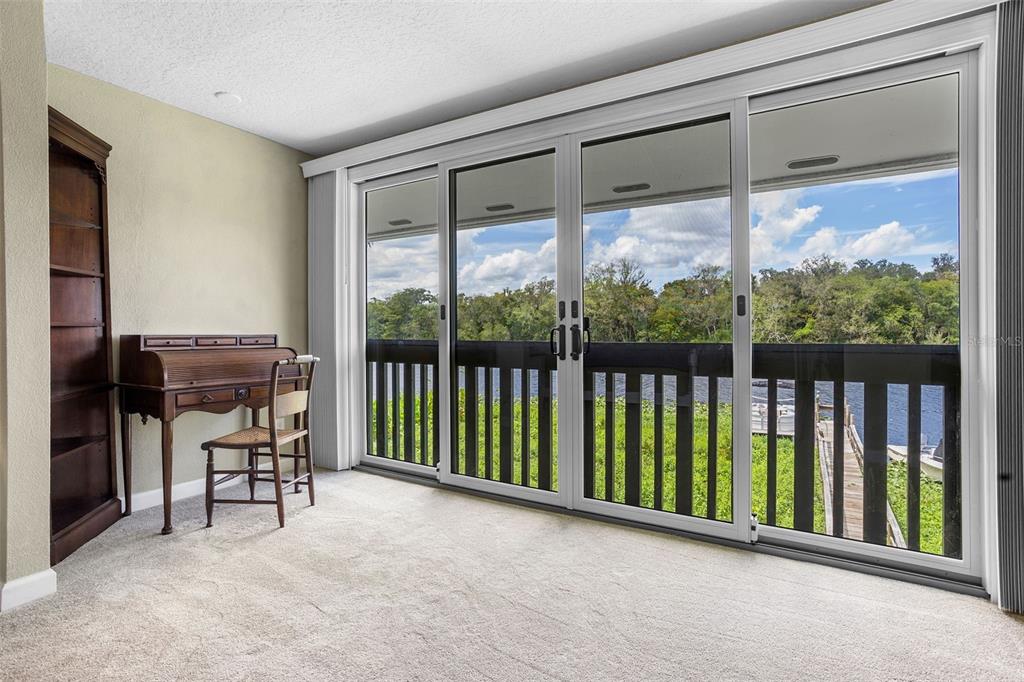 2329 River Ridge Road, Unit 15 DeLand, FL 32720 - Photo 14 of 40 a view of workspace with furniture and floor to ceiling window