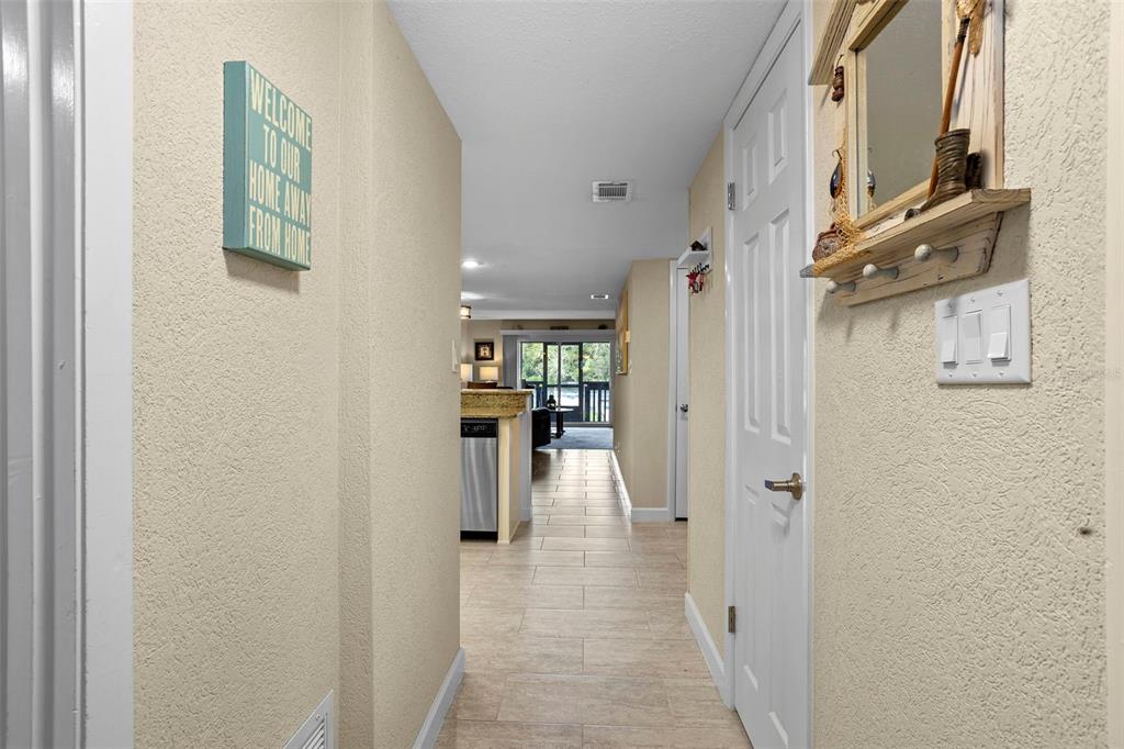 2329 River Ridge Road, Unit 15 DeLand, FL 32720 - Photo 23 of 40 a view of a hallway with a furniture and a refrigerator