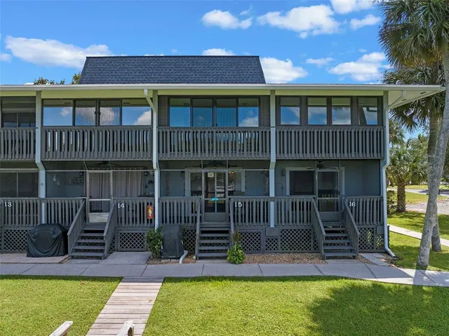 a view of house with swimming pool and porch