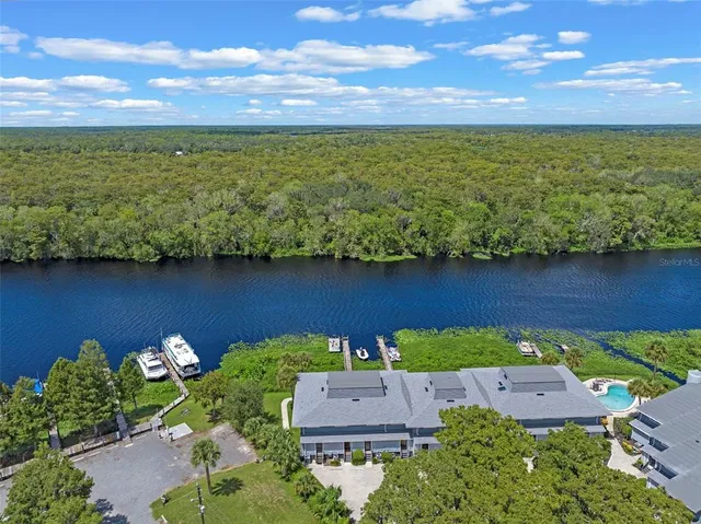an aerial view of a house with a lake view