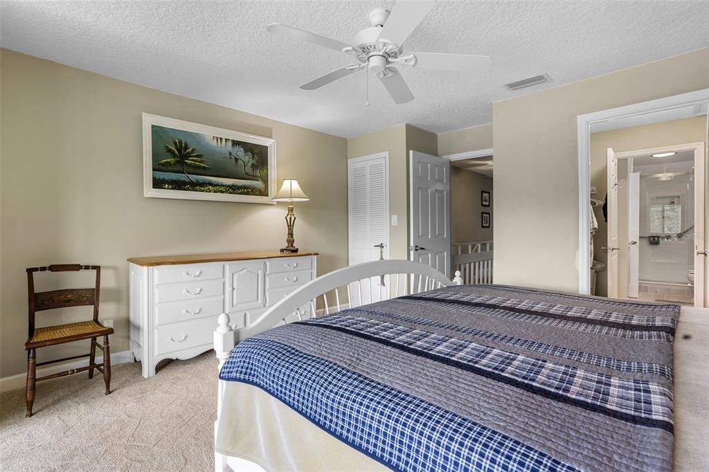 2329 River Ridge Road, Unit 15 DeLand, FL 32720 - Photo 6 of 40 a bedroom with a large bed and a chandelier