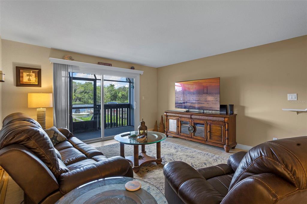 2329 River Ridge Road, Unit 15 DeLand, FL 32720 - Photo 10 of 40 a living room with furniture a flat screen tv and a window