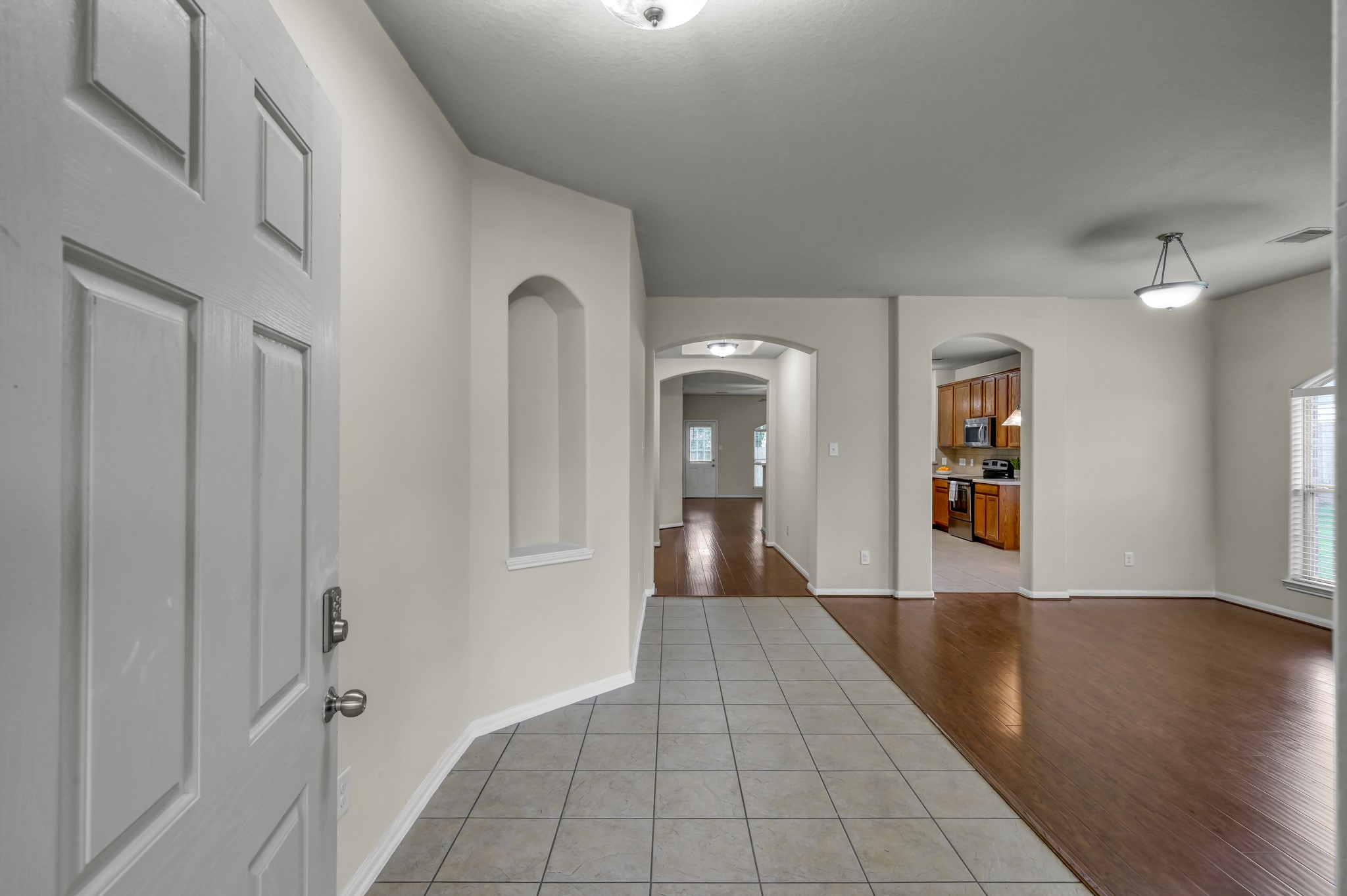 631 Timberstand Lane Spring, TX 77373 - Photo 4 of 38 Step inside to a spacious entryway with an open flow, high ceilings, and easy-maintenance flooring throughout.