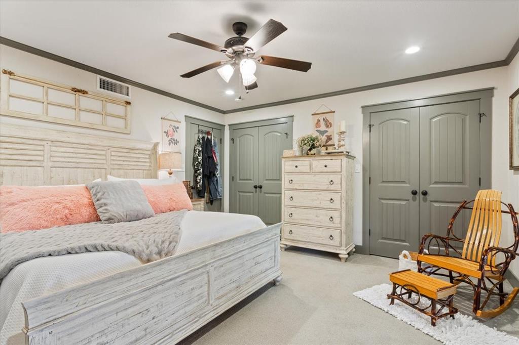 649 Wedgewood Drive China Spring, TX 76633 - Photo 12 of 39 Bedroom featuring ornamental molding, multiple closets, ceiling fan, and light colored carpet