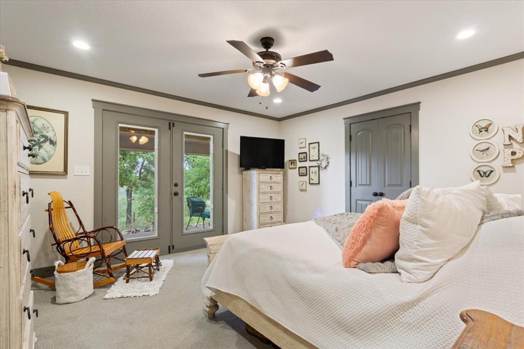 649 Wedgewood Drive China Spring, TX 76633 - Photo 13 of 39 Bedroom with french doors, a closet, ceiling fan, crown molding, and carpet floors