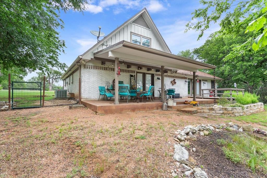 649 Wedgewood Drive China Spring, TX 76633 - Photo 32 of 39 Rear view of house with brick siding, a gate, board and batten siding, french doors, and a patio area